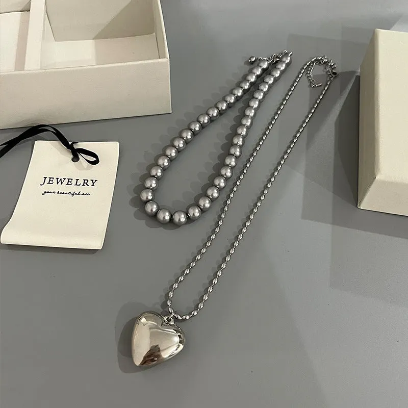 Wholesale Rice Bead Titanium Steel Necklace Hollow Heart Pendant Sweater Chain light_wish_jewels